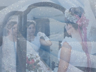 phot of a young girl looking at herself in the mirror with a blue sparkly treatment over the photograph